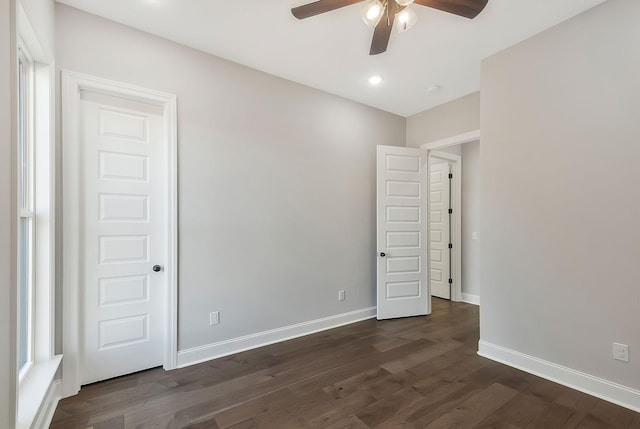 spare room featuring dark wood-type flooring, recessed lighting, a ceiling fan, and baseboards