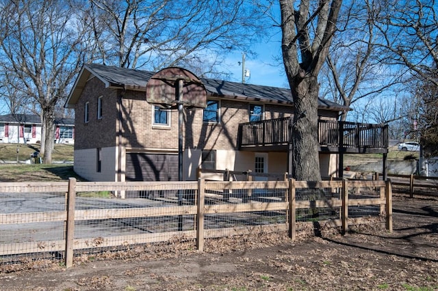 view of play area with a fenced front yard and a wooden deck