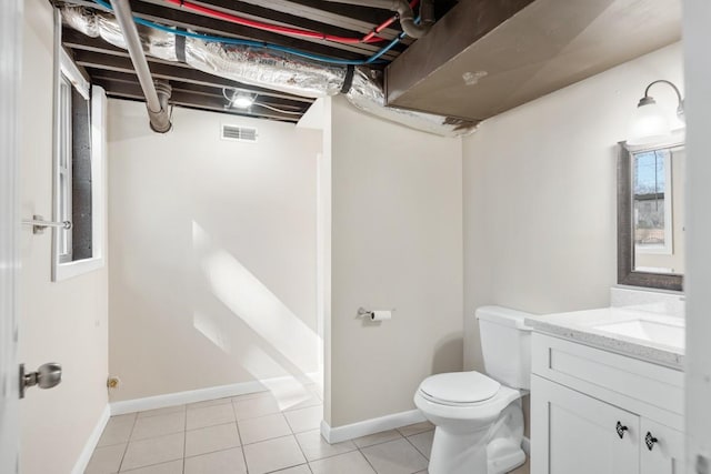 bathroom featuring baseboards, visible vents, toilet, tile patterned floors, and vanity