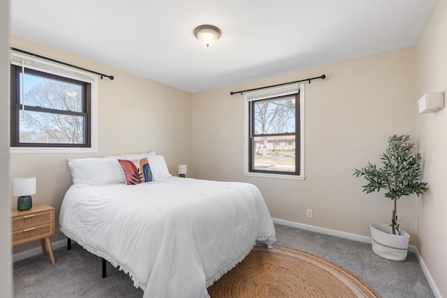 carpeted bedroom featuring baseboards