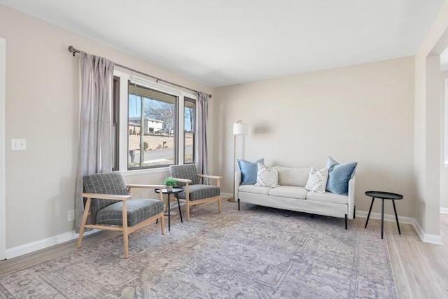 sitting room featuring baseboards and wood finished floors