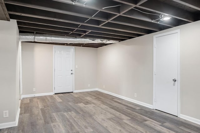 finished basement with baseboards and wood finished floors