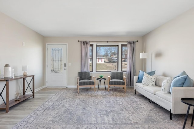 living area featuring wood finished floors and baseboards