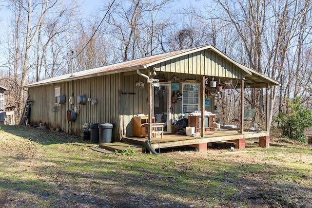 rear view of property featuring a deck