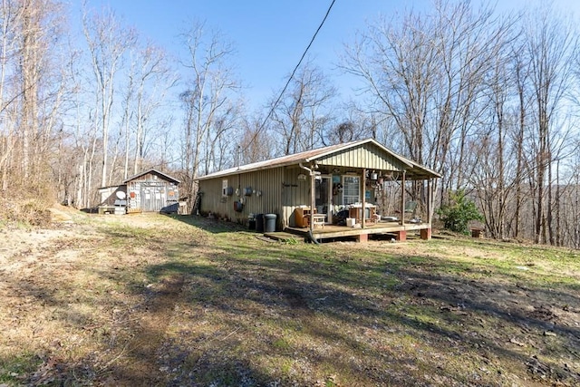 rear view of house featuring a lawn