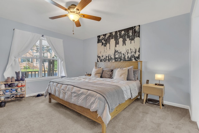 bedroom with baseboards, ceiling fan, and light colored carpet