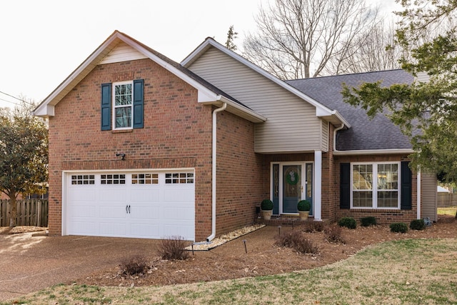 traditional-style house featuring a garage, driveway, and brick siding