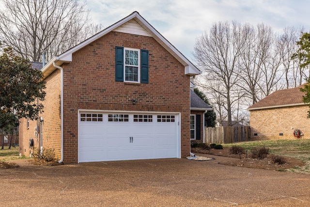 traditional-style house with a garage, concrete driveway, brick siding, and a shingled roof