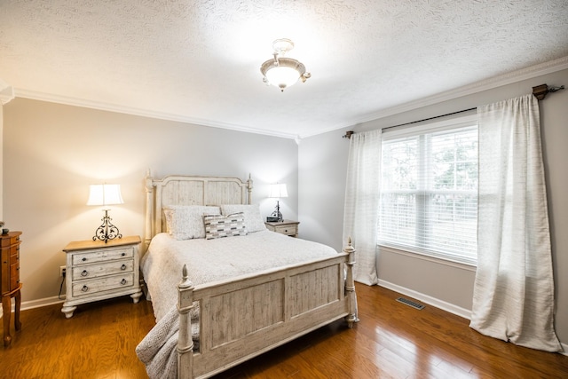 bedroom featuring baseboards, visible vents, dark wood finished floors, and crown molding