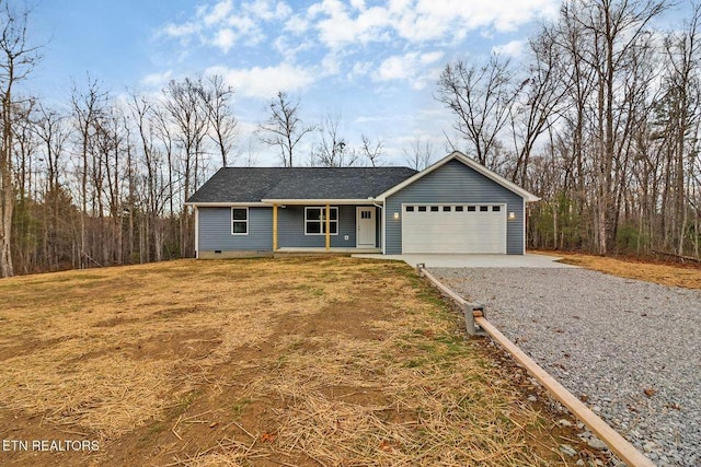 ranch-style home featuring an attached garage, crawl space, driveway, and a front yard