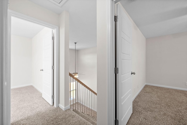 hallway featuring baseboards and carpet flooring