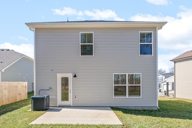 rear view of house with a yard, cooling unit, a patio, and fence