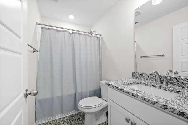 bathroom with shower / bath combo, vanity, and toilet