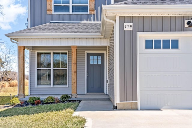 entrance to property with board and batten siding, roof with shingles, a porch, and a garage