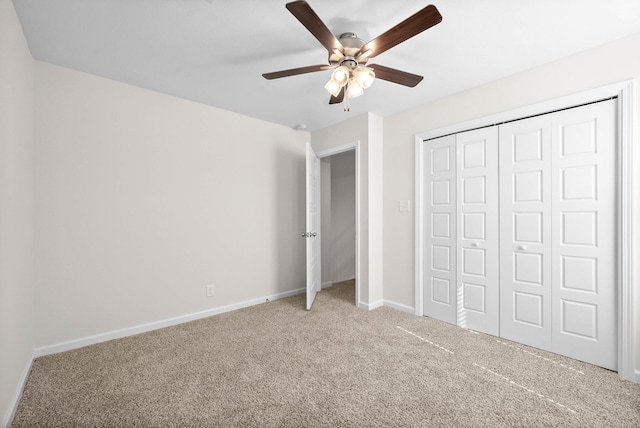 unfurnished bedroom featuring a ceiling fan, a closet, baseboards, and carpet flooring