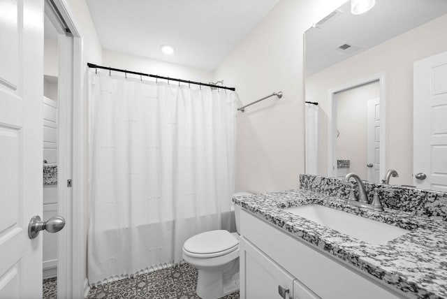 bathroom featuring toilet, vanity, visible vents, and shower / bathtub combination with curtain