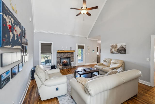 living room with a fireplace, a ceiling fan, wood finished floors, high vaulted ceiling, and baseboards