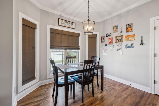 dining space with an inviting chandelier, baseboards, dark wood finished floors, and crown molding