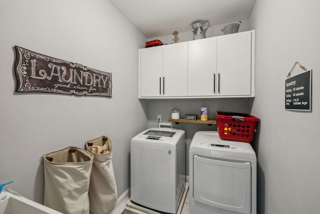 washroom featuring cabinet space and separate washer and dryer