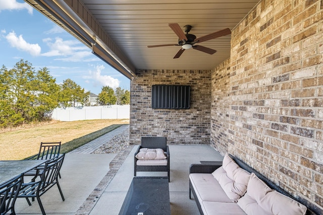 view of patio / terrace with outdoor lounge area, fence, and a ceiling fan