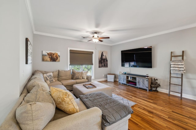 living area featuring ceiling fan, ornamental molding, wood finished floors, and baseboards