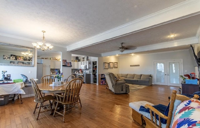 dining space featuring a textured ceiling, hardwood / wood-style floors, and ornamental molding