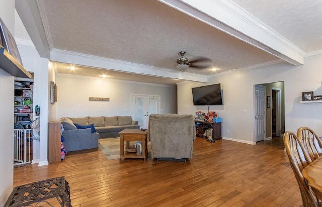 living area featuring a textured ceiling, french doors, hardwood / wood-style floors, and a ceiling fan