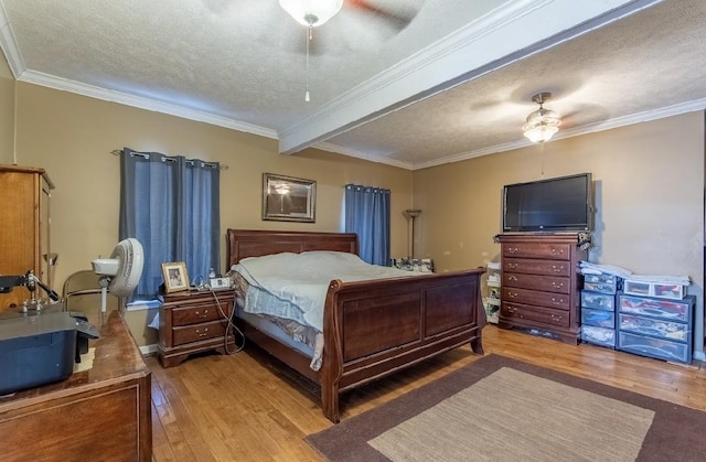 bedroom with light wood-style floors, a ceiling fan, ornamental molding, and a textured ceiling