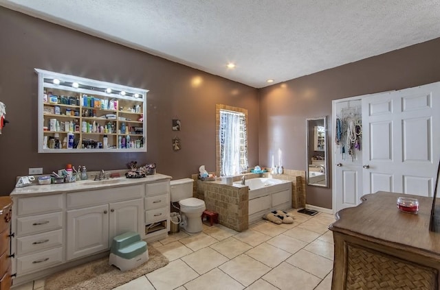 full bathroom with toilet, a textured ceiling, vanity, a bath, and tile patterned floors