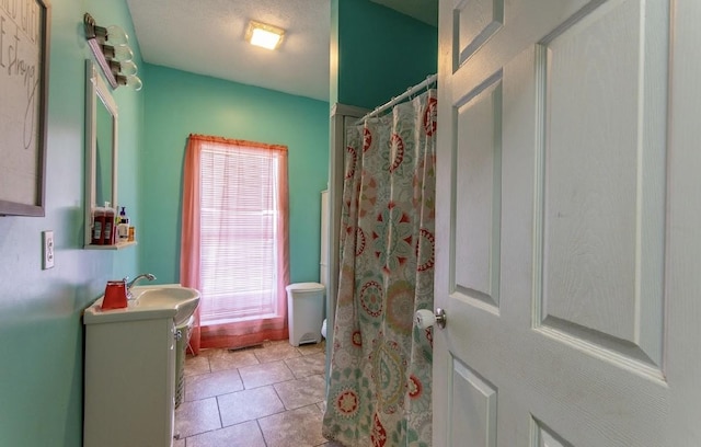 bathroom with curtained shower, tile patterned flooring, and vanity