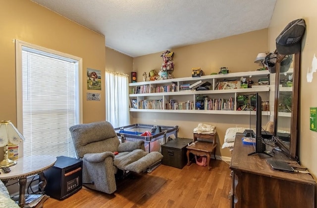 living area featuring a textured ceiling and light wood-style flooring