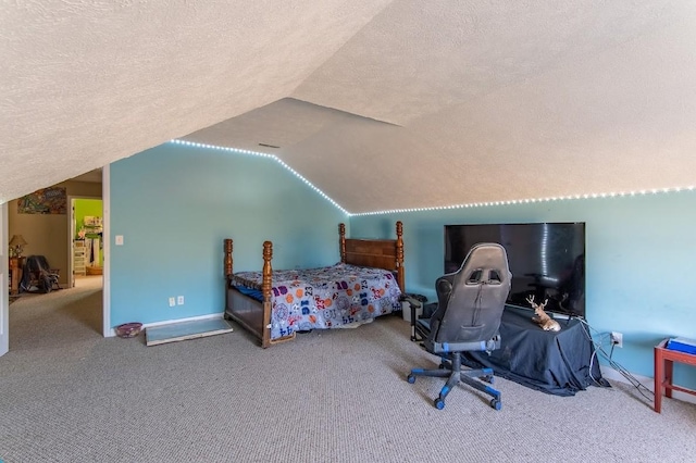 carpeted bedroom with lofted ceiling, a textured ceiling, and baseboards