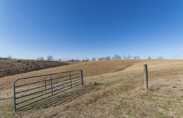 exterior space featuring fence and a rural view