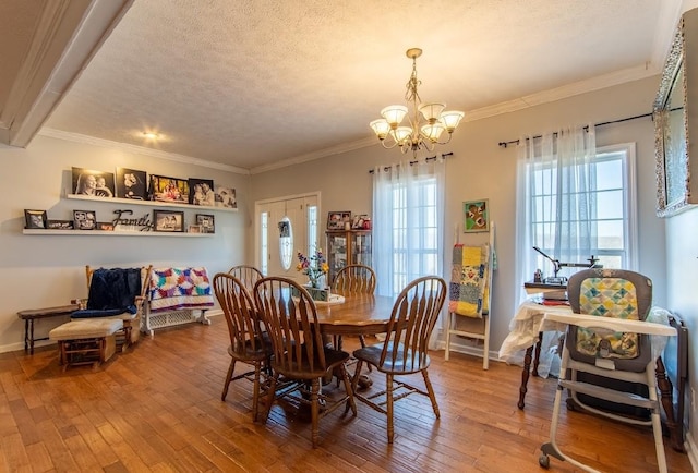 dining space featuring plenty of natural light, a textured ceiling, and hardwood / wood-style flooring