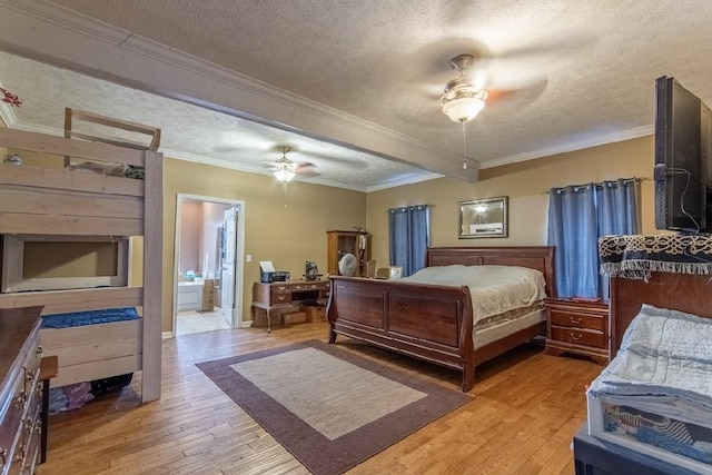 bedroom with a textured ceiling, connected bathroom, light wood-style flooring, a ceiling fan, and ornamental molding