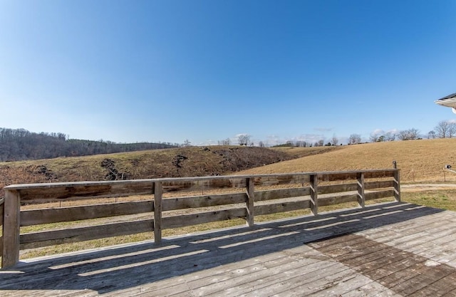 wooden deck with a rural view