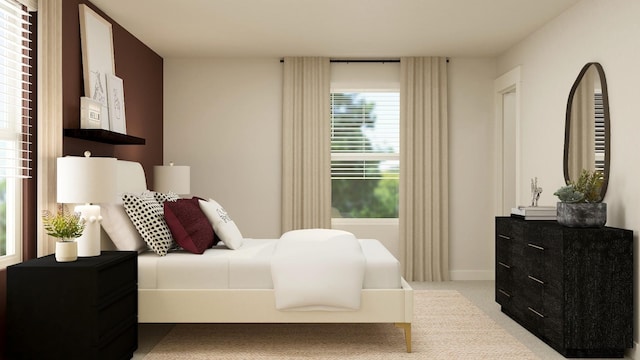 bedroom featuring baseboards and light colored carpet