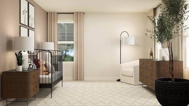 living area featuring baseboards and light colored carpet