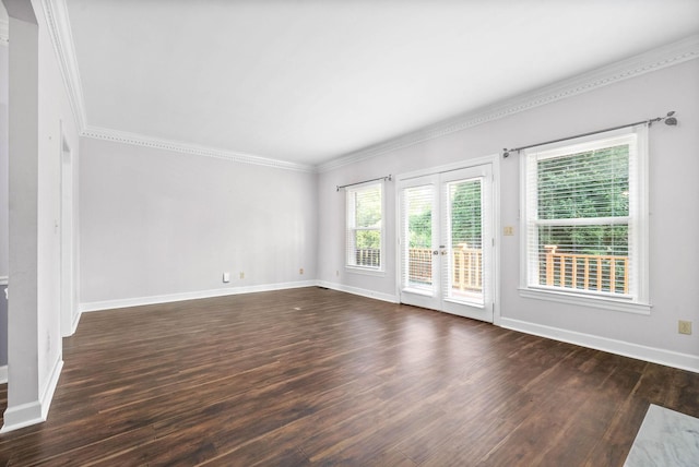 empty room featuring ornamental molding, dark wood finished floors, and baseboards