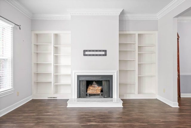 unfurnished living room featuring a fireplace with raised hearth, visible vents, baseboards, ornamental molding, and dark wood finished floors