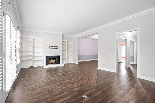 unfurnished living room featuring crown molding, baseboards, a fireplace with raised hearth, and dark wood finished floors