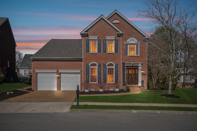 view of front facade with brick siding, an attached garage, and concrete driveway