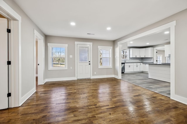 foyer featuring recessed lighting, dark wood-style flooring, visible vents, and baseboards