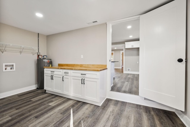 laundry room featuring hookup for a washing machine, laundry area, visible vents, water heater, and dark wood-style floors