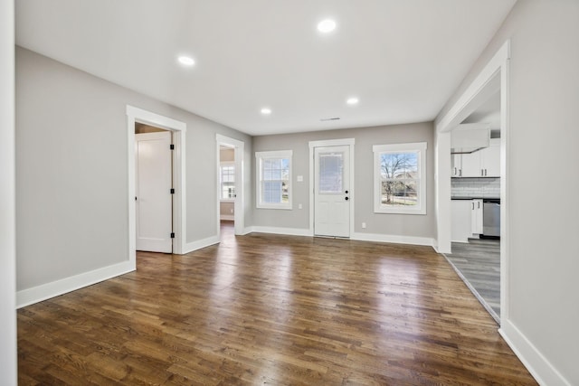 foyer entrance featuring dark wood-type flooring, recessed lighting, and a healthy amount of sunlight