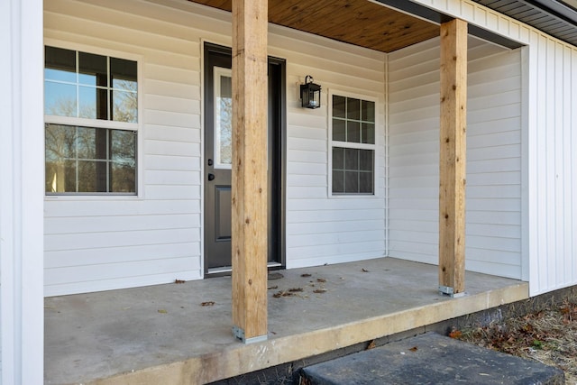 entrance to property with board and batten siding and covered porch