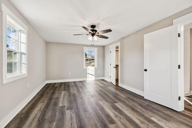 unfurnished room with dark wood finished floors, baseboards, and ceiling fan