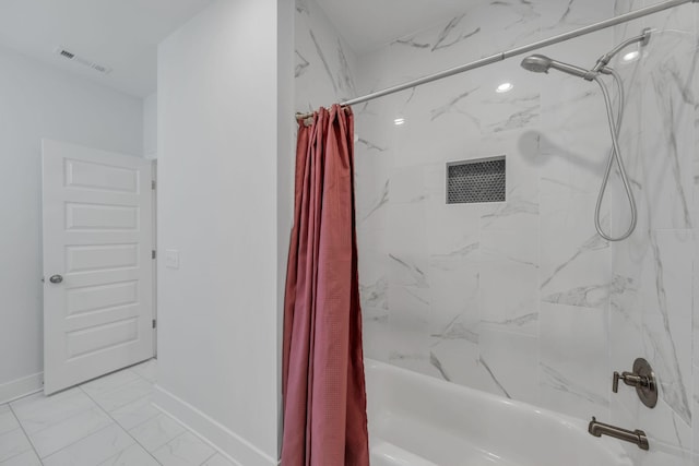 bathroom with marble finish floor, visible vents, shower / bath combo, and baseboards