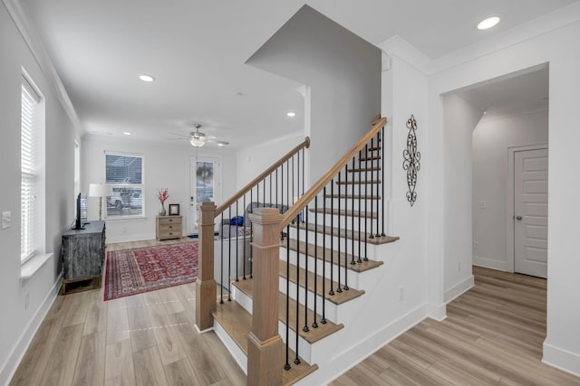 staircase with recessed lighting, crown molding, baseboards, and wood finished floors