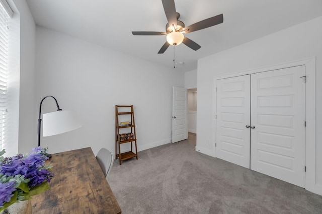 unfurnished bedroom with ceiling fan, a closet, baseboards, and light colored carpet